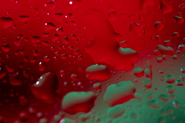 This macro and abstract photo is created by placing color objects outside the focus of the camera lens.The water or oil is on a glass material.