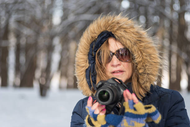 istock Winter nature photographer with camera 1093249394