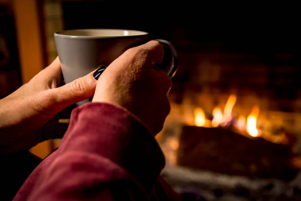 istock woman is warming in a fireplace 1093249622