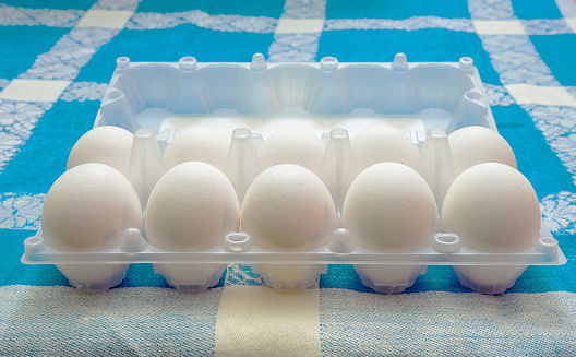 Ten fresh eggs in a standard package on the table