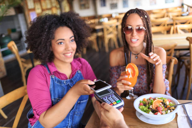 istock African woman using credit card in restaurant 1093253276