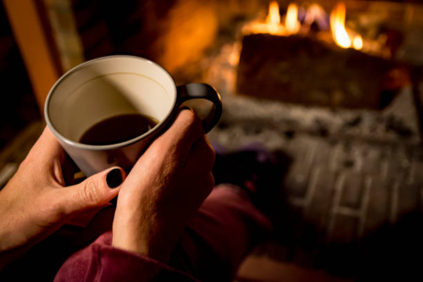 istock woman is warming in a fireplace 1093253552