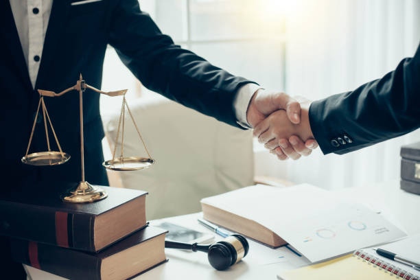 istock Businessman and lawyer shaking hands. 1093255758
