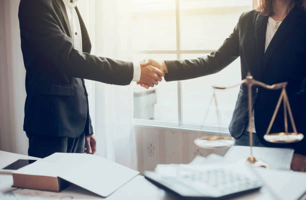 istock Businessman and lawyer shaking hands. 1093255786