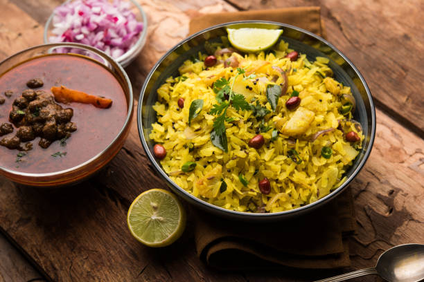 istock Aloo/Kanda Poha or Tarri Pohe with spicy chana masala/curry. selective focus 1093256030