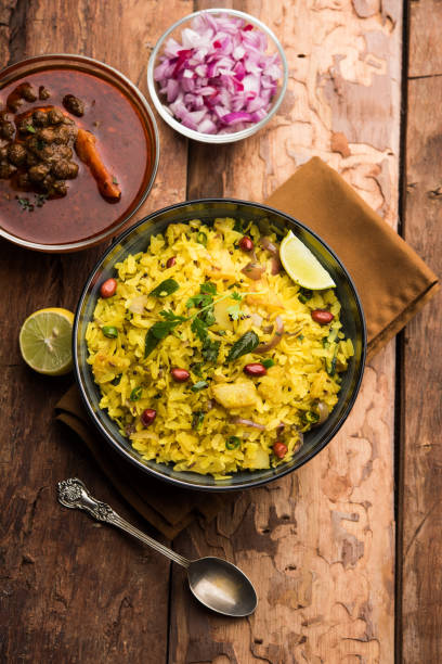 istock Aloo/Kanda Poha or Tarri Pohe with spicy chana masala/curry. selective focus 1093256130