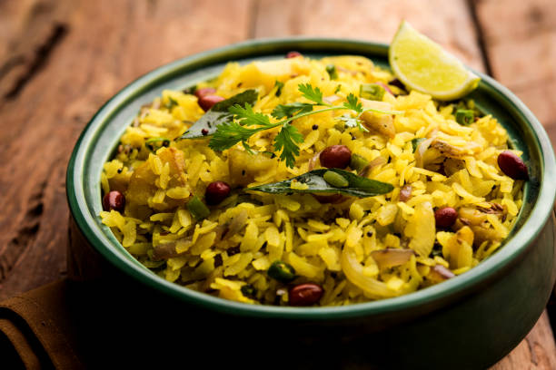 istock Aloo/Kanda Poha or Tarri Pohe with spicy chana masala/curry. selective focus 1093257456