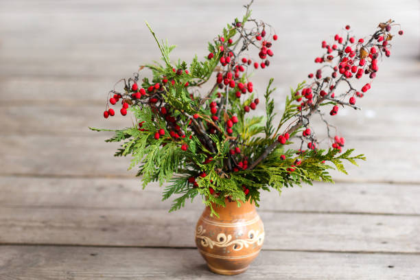 istock Vase with branches of a tree with red berries. 1093259800