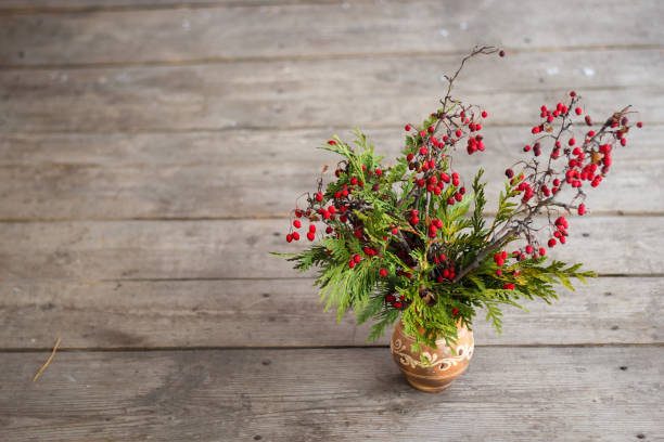 istock Vase with branches of a tree with red berries. 1093259802