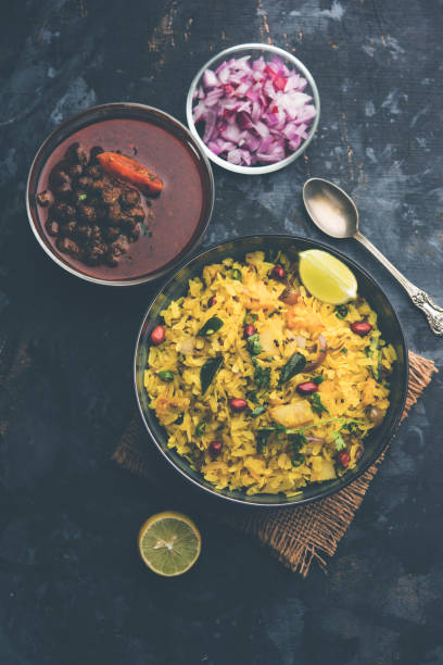 istock Aloo/Kanda Poha or Tarri Pohe with spicy chana masala/curry. selective focus 1093260712