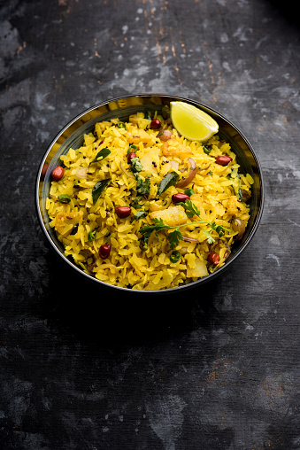 Aloo/Kanda Poha or Tarri Pohe with spicy chana masala/curry. selective focus