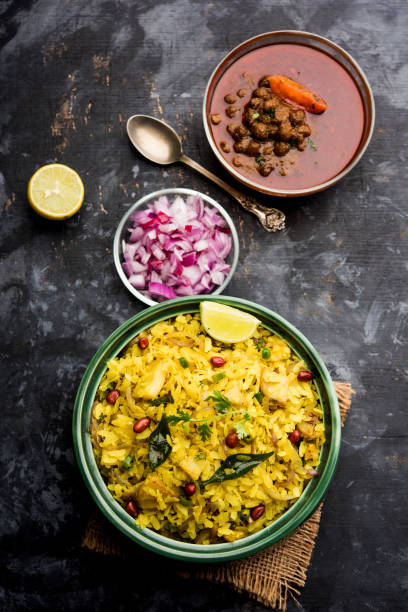 istock Aloo/Kanda Poha or Tarri Pohe with spicy chana masala/curry. selective focus 1093262508