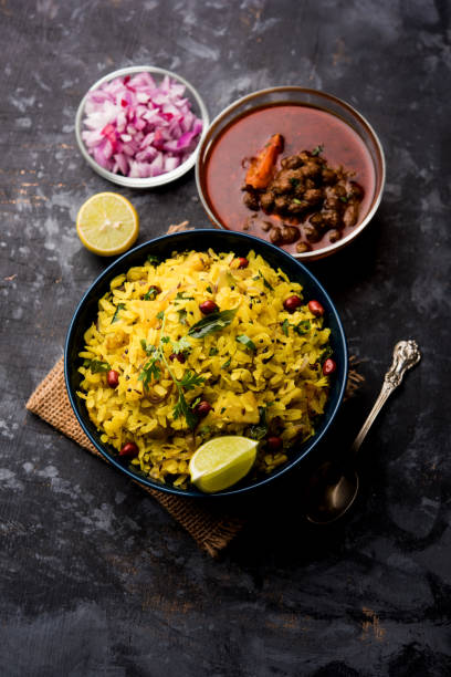 istock Aloo/Kanda Poha or Tarri Pohe with spicy chana masala/curry. selective focus 1093263266