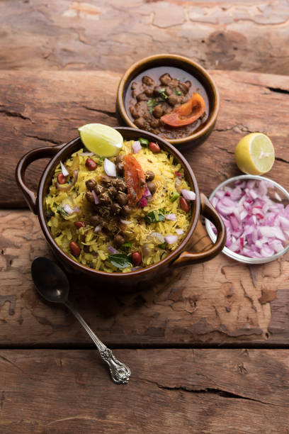 istock Aloo/Kanda Poha or Tarri Pohe with spicy chana masala/curry. selective focus 1093265414