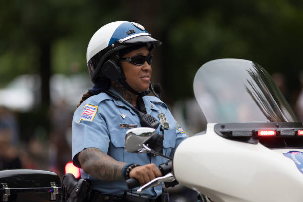 Washington, D.C., USA - May 28, 2018: The National Memorial Day Parade, Members of the Washington D.C. Metropolitan Police, on motorcycles carry the American flag