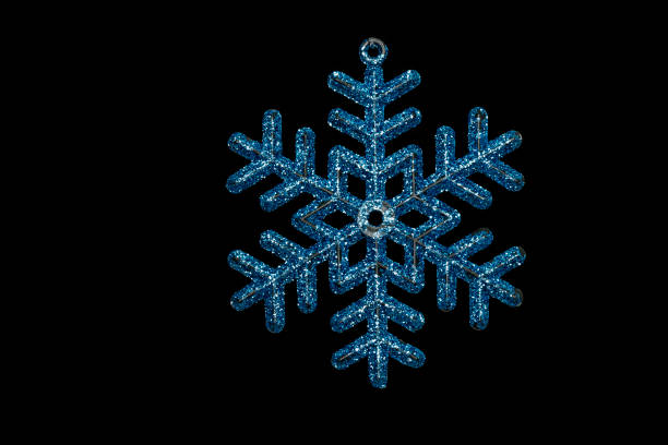 Christmas tree shining snowflake isolated on black background