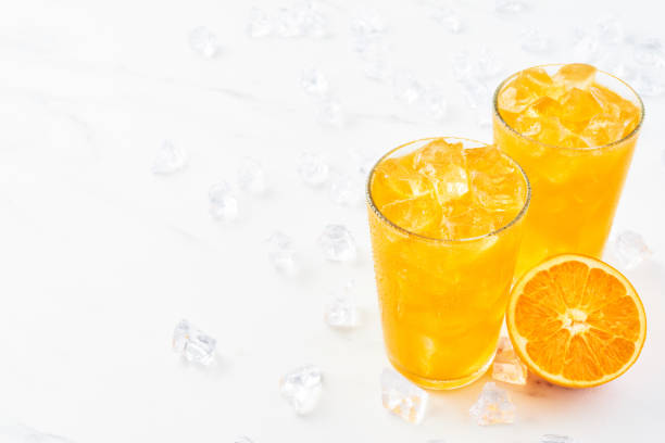 istock Fresh orange juice with ice in tall glass 1093271864