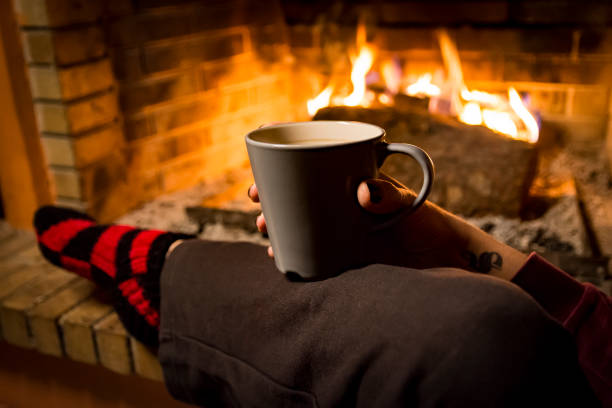 istock woman is warming in a fireplace 1093271882