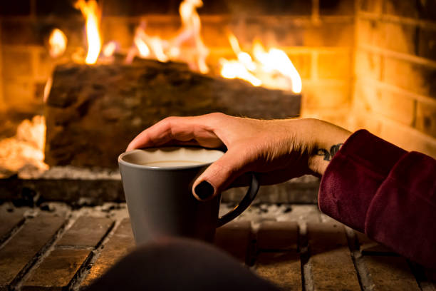 istock woman is warming in a fireplace 1093272462