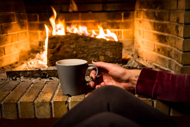 istock woman is warming in a fireplace 1093272464