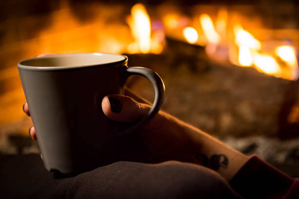 istock woman is warming in a fireplace 1093274236