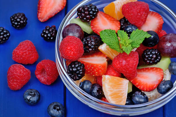 istock Berries salad in a transparent bowl on wooden table 1093281108