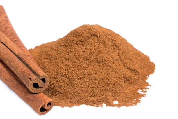 istock Cinnamon powder and sticks on white background 1093281344