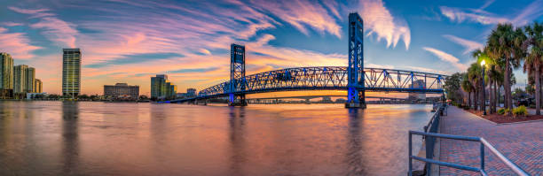 JACKSONVILLE FL MAIN ST BRIDGE DOWNTOWN JACKSONVILLE FL MAIN ST BRIDGE DOWNTOWN, AT SUNSET PANO johns stock pictures, royalty-free photos & images