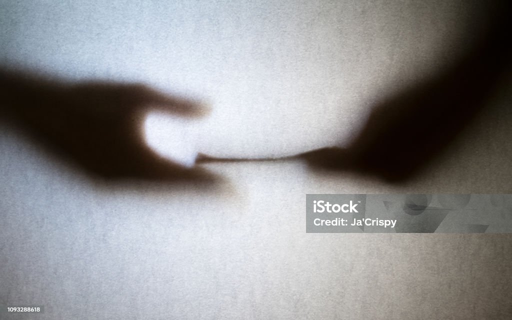 Silhouette of business man hands giving bribe isolated on grey background Corruption Stock Photo