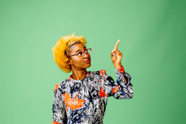 istock Young woman pointing up 1093290410