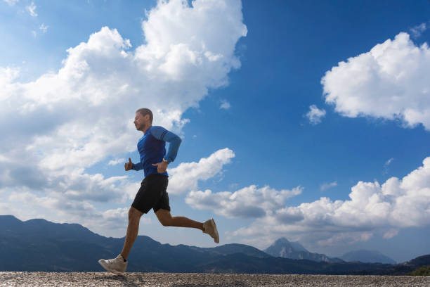 Sportsman running on asphalt road
