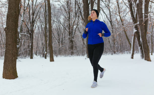 istock Woman running in snowy weather 1093300922