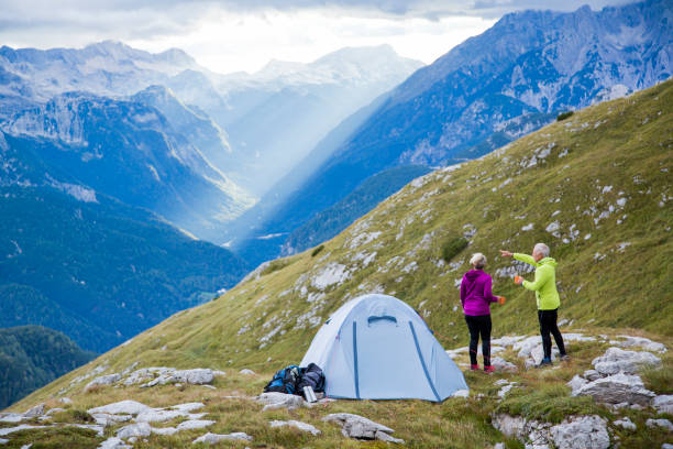 istock Couple camping on the mountain looking at view 1093304598