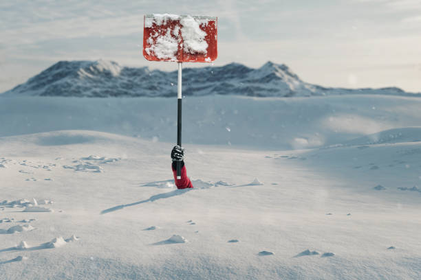 snow covered hand stretching out with snow shovel to signal help because of snow avalanche . danger extreme concept - snow digging horizontal people imagens e fotografias de stock