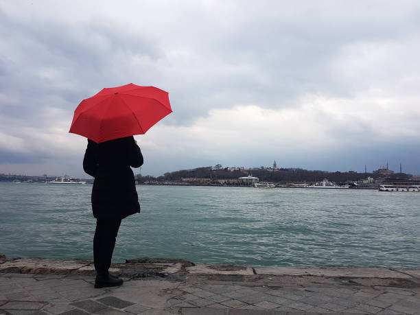 istock women with umbrella 1093307432