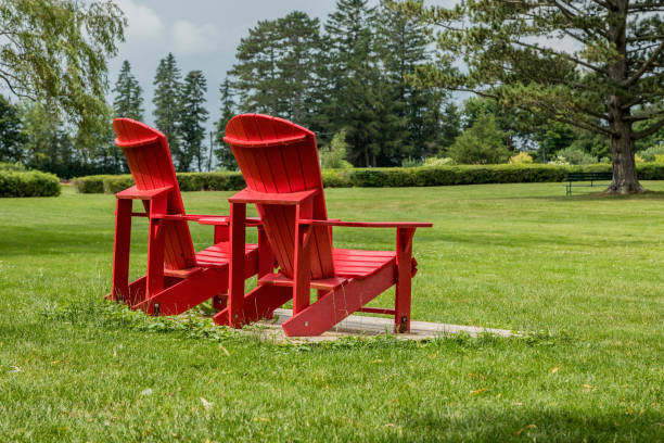 istock Two Red Adirondack chairs in the garden 1093309800