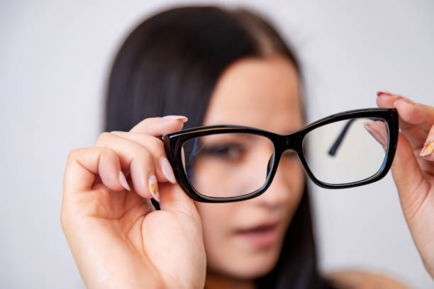 istock Modern eyeglasses with black frame in woman's hands. 1093313072
