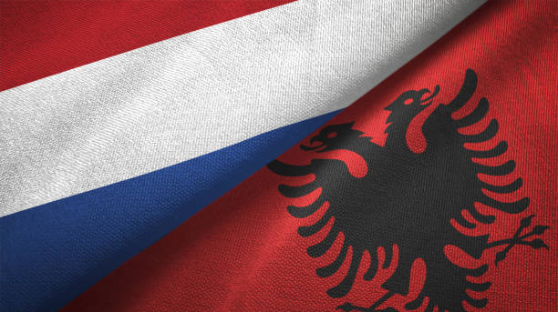 istock Albania and Netherlands two flags together textile cloth fabric texture 1093316766
