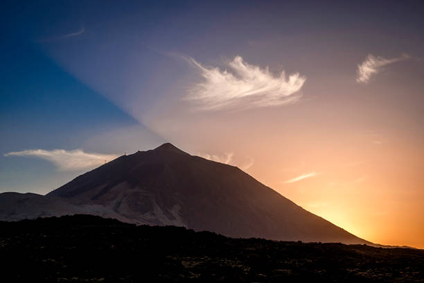 istock Dramatic sunset behind Volcano Mount El Teide, viewed from nearby KM 32,5, Road TF-21, Teide National Park (Parque nacional del Teide), Tenerife, Canary Islands, Spain 1093316950