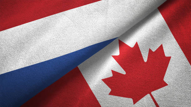 istock Canada and Netherlands two flags together textile cloth fabric texture 1093317030