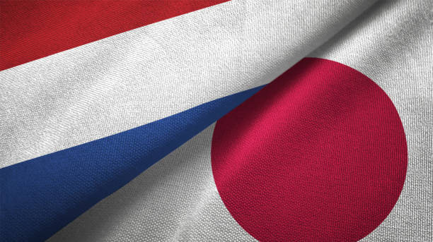istock Japan and Netherlands two flags together textile cloth fabric texture 1093317442