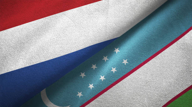 istock Uzbekistan and Netherlands two flags together textile cloth fabric texture 1093319138