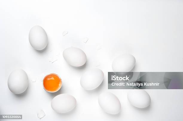 Eggsone Cracked With Shell And Group Of Whole Unheard Eggs On A White Background Stock Photo - Download Image Now