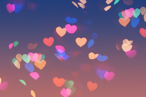 Bokeh hearts lights background. Bokeh romantic defocused night background. Valentines day hearts background can be used for web design, wallpapers, printed products and other.