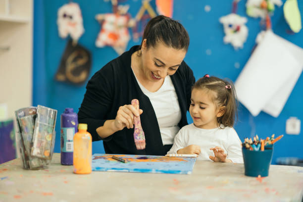 istock Mother and child daughter draw paints 1093325254