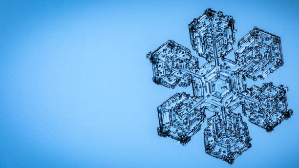 istock Beautiful snow flake on a light blue background close up 1093325274