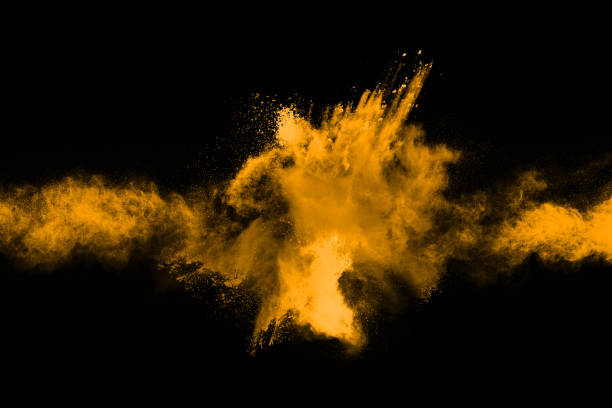 istock Freeze motion of yellow dust explosion isolated on black background. 1093325430