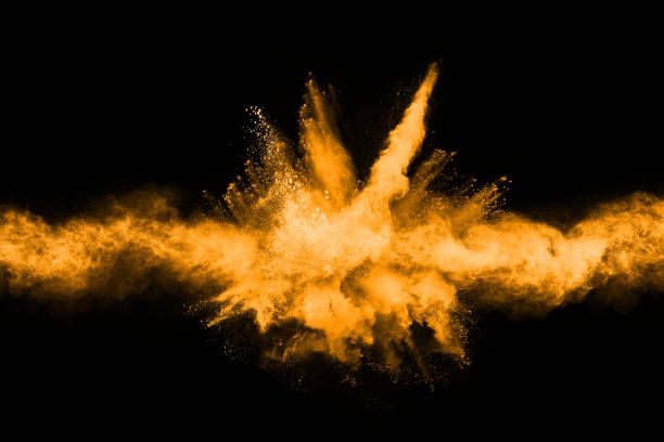 istock Freeze motion of yellow dust explosion isolated on black background. 1093325458