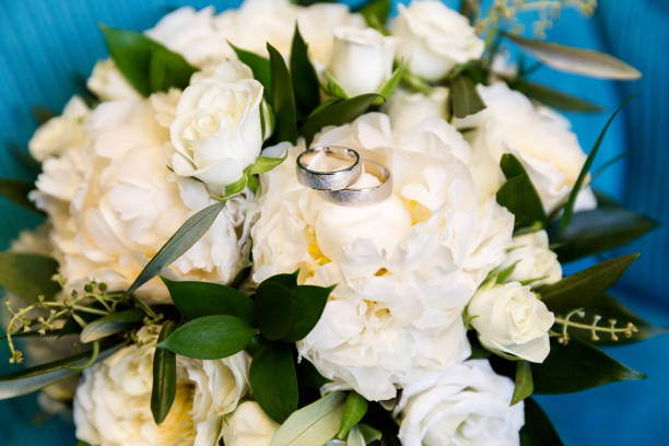 istock Wedding rings on a bouquet of flowers 1093347152