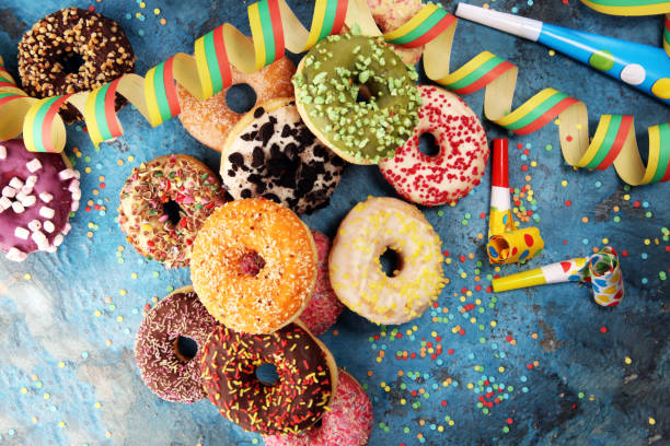 istock assorted donuts with chocolate frosted, pink glazed and sprinkles donuts 1093355666